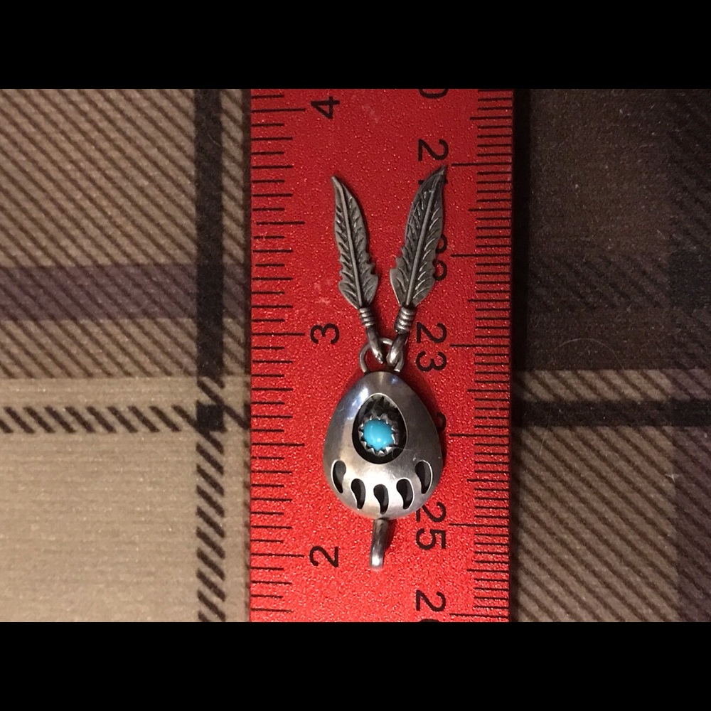 Bear claw pendant marked.